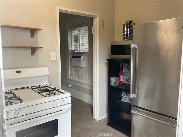 a white stove top oven sitting inside of a kitchen