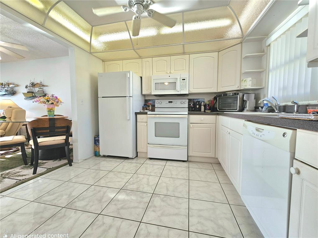 4525 Cove Circle, Unit 1002 St. Petersburg, FL 33708 - Photo 11 of 42 a kitchen with a stove a sink and a refrigerator
