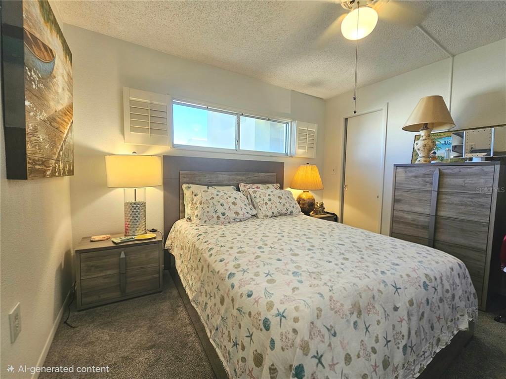 4525 Cove Circle, Unit 1002 St. Petersburg, FL 33708 - Photo 13 of 42 a bedroom with a bed and a cabinets