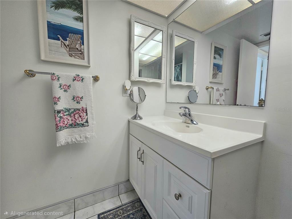 4525 Cove Circle, Unit 1002 St. Petersburg, FL 33708 - Photo 16 of 42 a bathroom with a sink and a mirror