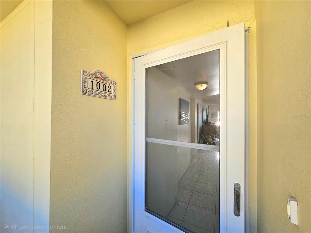 4525 Cove Circle, Unit 1002 St. Petersburg, FL 33708 - Photo 2 of 42 a view of a bathroom from a hallway
