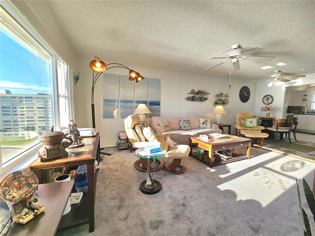 4525 Cove Circle, Unit 1002 St. Petersburg, FL 33708 - Photo 25 of 42 a living room with furniture and a large window
