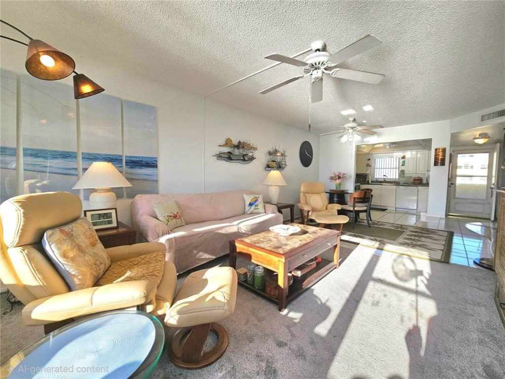 4525 Cove Circle, Unit 1002 St. Petersburg, FL 33708 - Photo 27 of 42 a living room with furniture a rug and white walls
