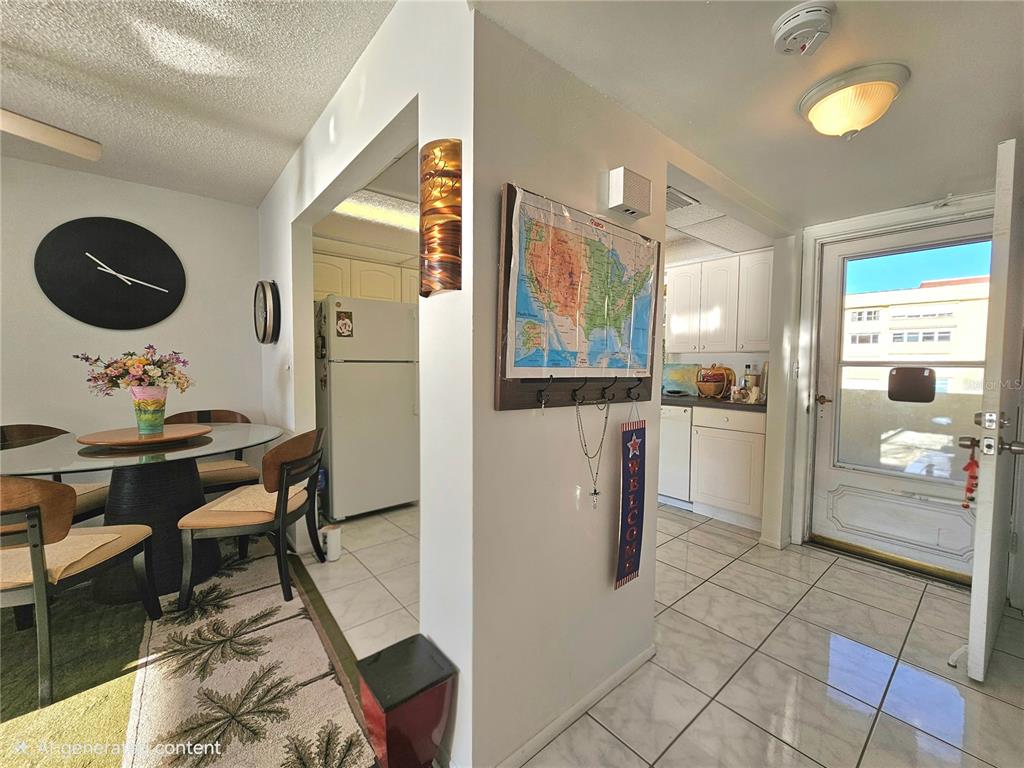 4525 Cove Circle, Unit 1002 St. Petersburg, FL 33708 - Photo 29 of 42 a open kitchen with stainless steel appliances granite countertop a refrigerator and microwave