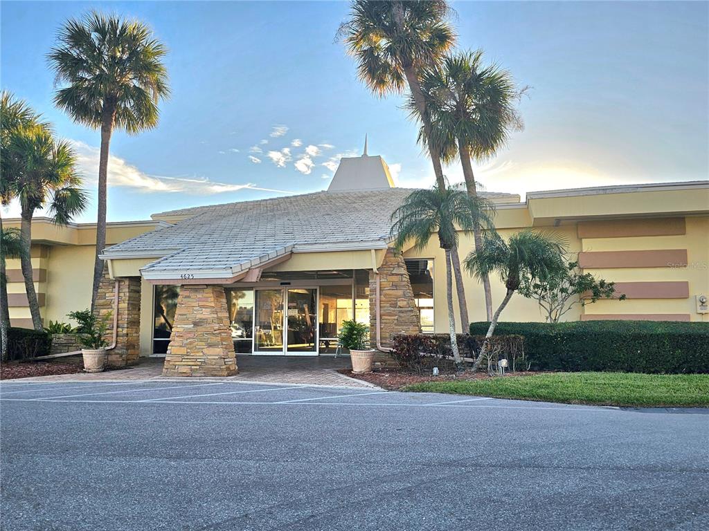4525 Cove Circle, Unit 1002 St. Petersburg, FL 33708 - Photo 34 of 42 a front view of house with yard and green space