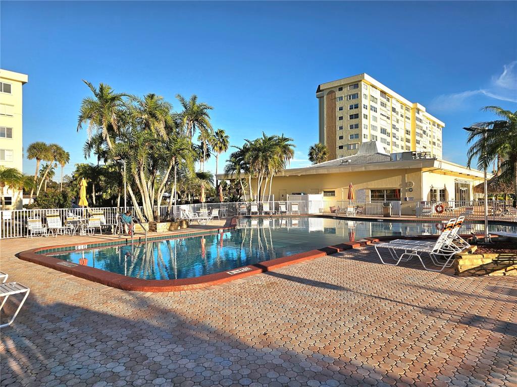 4525 Cove Circle, Unit 1002 St. Petersburg, FL 33708 - Photo 35 of 42 a view of a swimming pool with outdoor seating