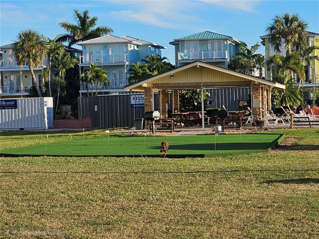 4525 Cove Circle, Unit 1002 St. Petersburg, FL 33708 - Photo 38 of 42 a view of a big house with a yard