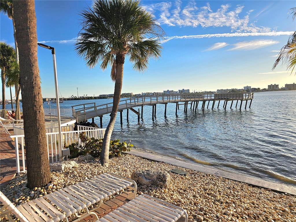 4525 Cove Circle, Unit 1002 St. Petersburg, FL 33708 - Photo 39 of 42 a view of a terrace with a bench