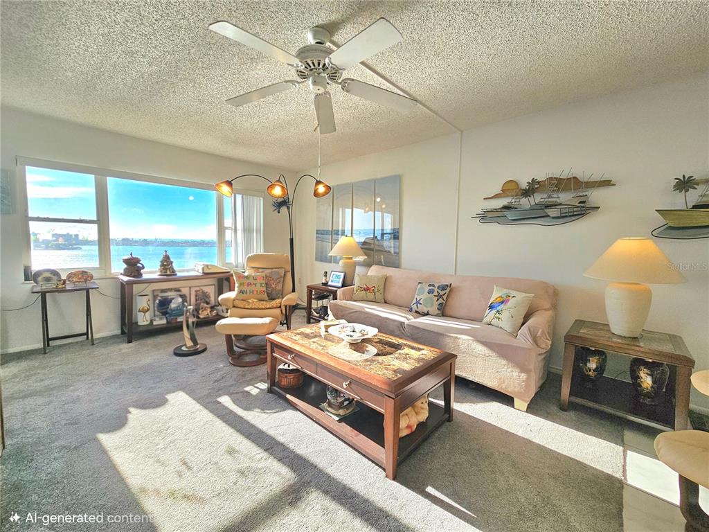 4525 Cove Circle, Unit 1002 St. Petersburg, FL 33708 - Photo 4 of 42 a living room with furniture and a chandelier