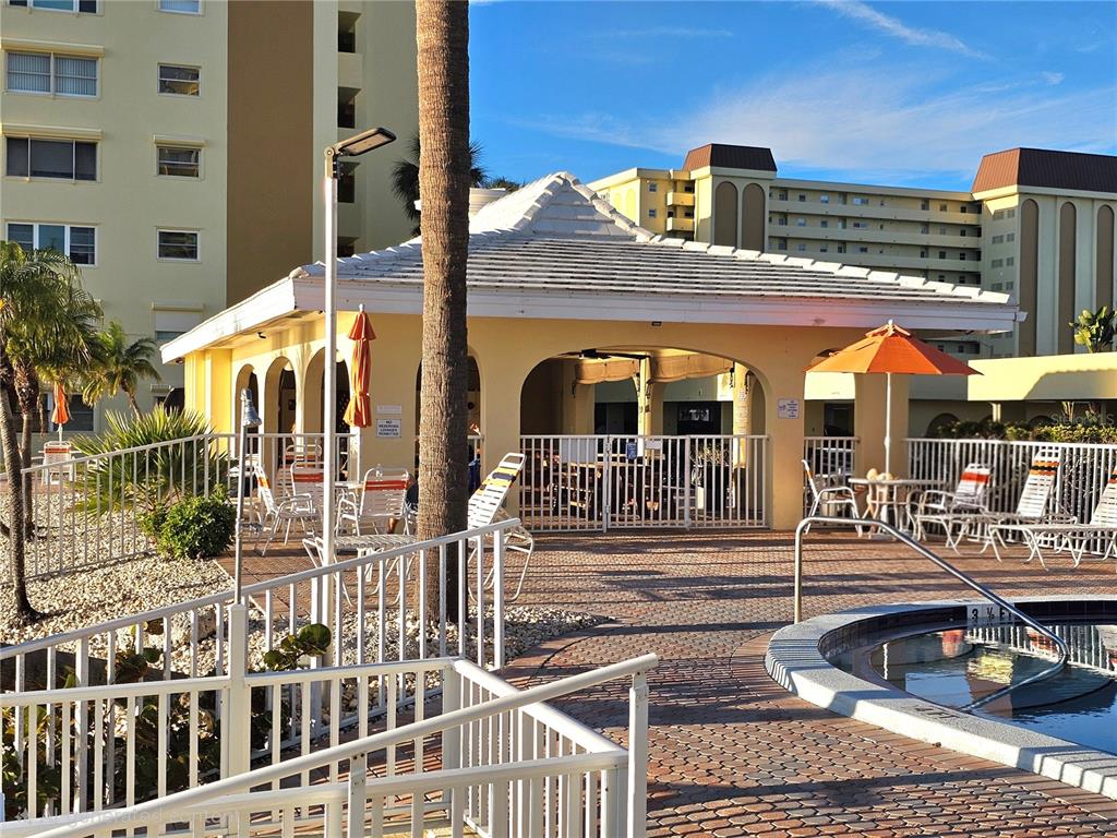 4525 Cove Circle, Unit 1002 St. Petersburg, FL 33708 - Photo 41 of 42 front view of a building with a fountain