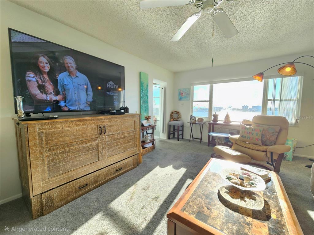 4525 Cove Circle, Unit 1002 St. Petersburg, FL 33708 - Photo 7 of 42 a bed room with furniture and window