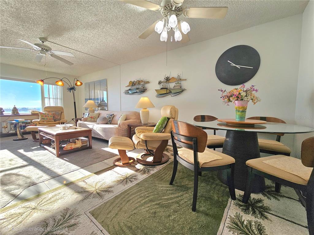 4525 Cove Circle, Unit 1002 St. Petersburg, FL 33708 - Photo 8 of 42 a living room with lots of furniture and a chandelier