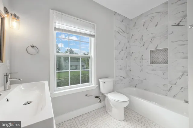 a bathroom with a bathtub and a toilet