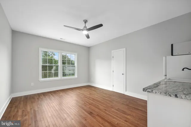 a view of a kitchen and wooden floor
