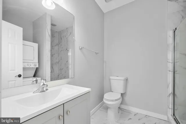 a bathroom with a toilet a sink and a mirror