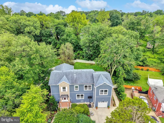 an aerial view of a house with a garden and trees