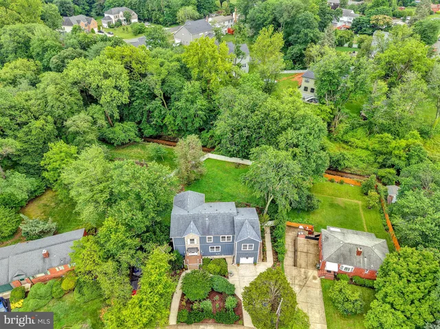 an aerial view of a house with a yard and lake view