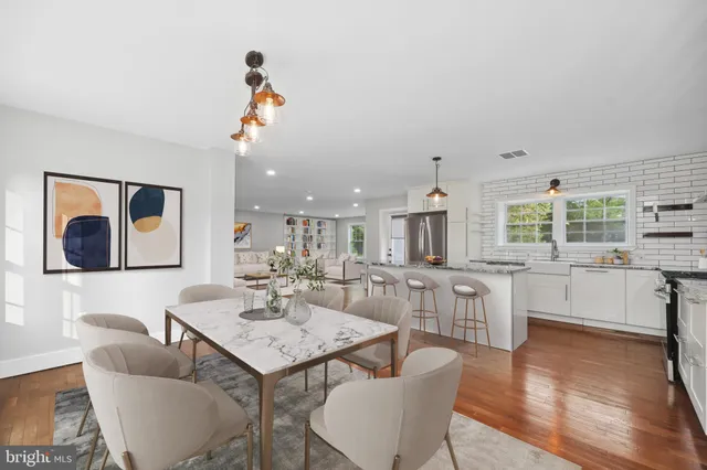 a living room with fireplace furniture and a wooden floor