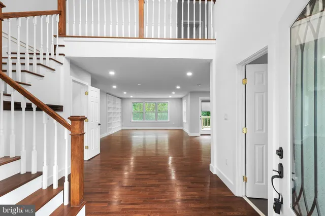 a view of an entryway with wooden floor and staircase