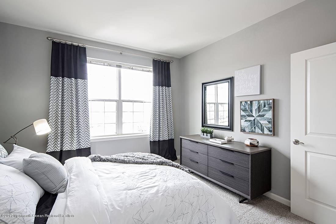 249 Broad Street, Unit 413 Matawan, NJ 07747 - Photo 22 of 27 a bedroom with a bed and a window