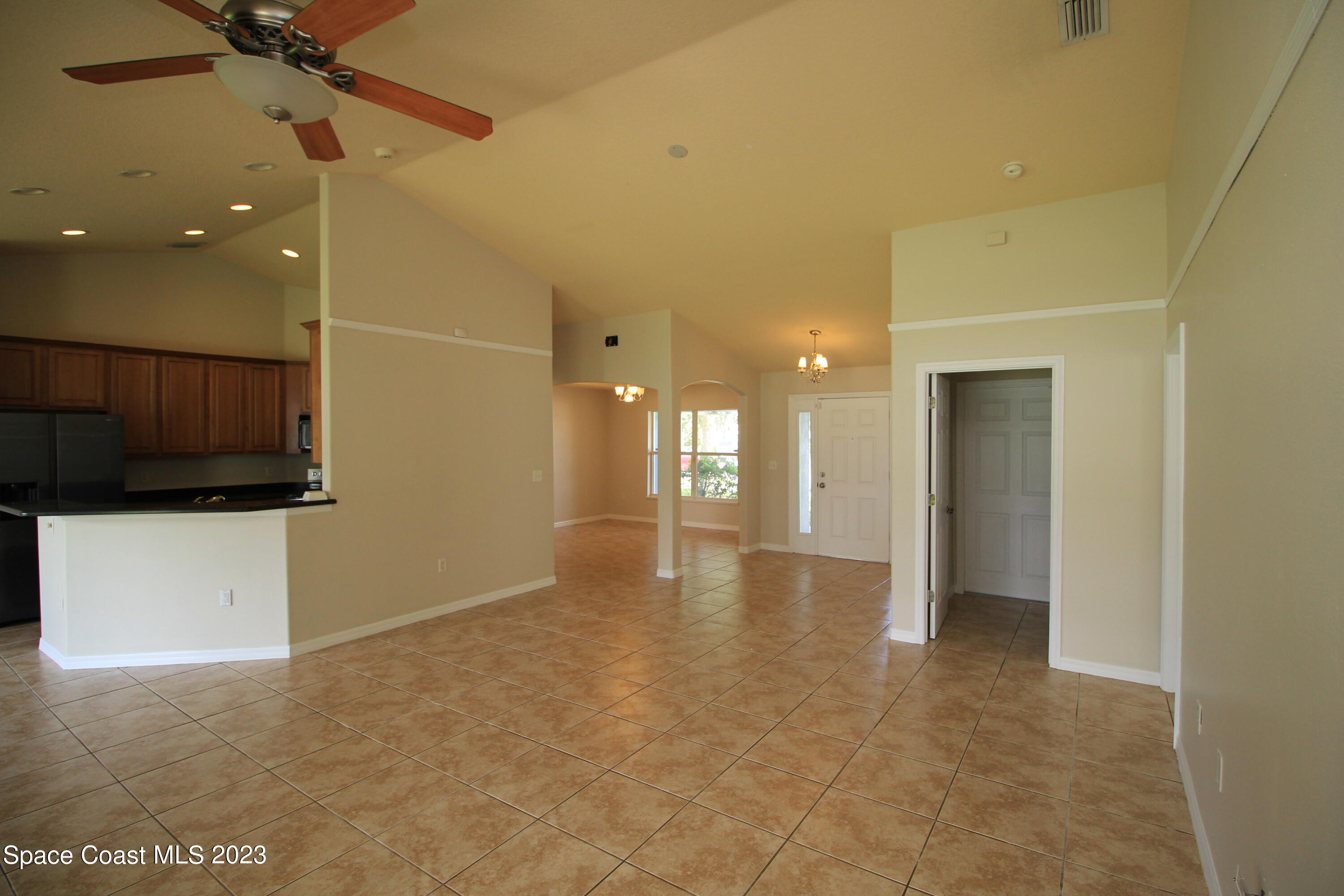 492 Eldron Boulevard Southeast Palm Bay, FL 32907 - Photo 11 of 28 a view of a room with a ceiling fan and entryway