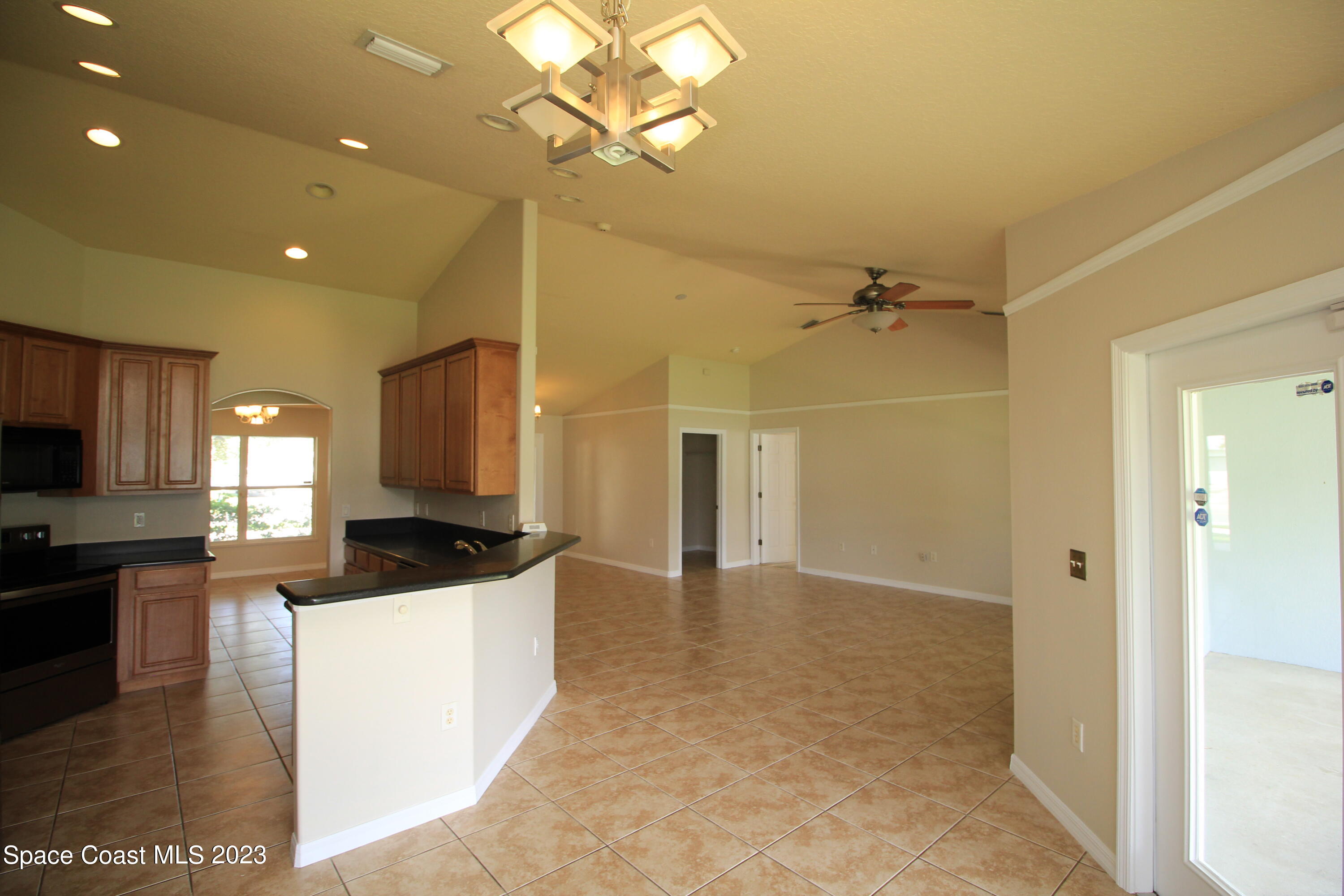 492 Eldron Boulevard Southeast Palm Bay, FL 32907 - Photo 13 of 28 a kitchen with kitchen island a sink stainless steel appliances and cabinets