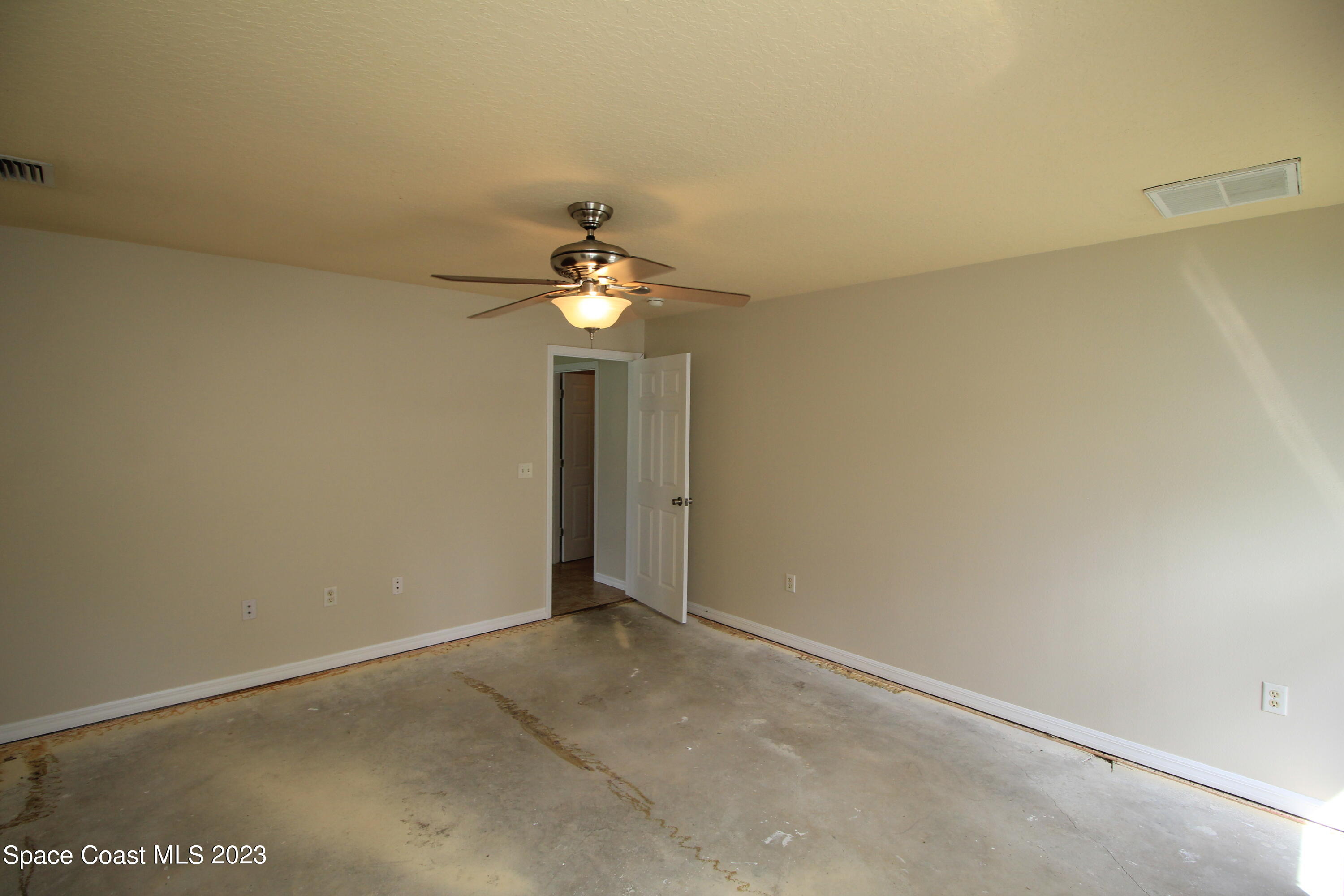 492 Eldron Boulevard Southeast Palm Bay, FL 32907 - Photo 26 of 28 an empty room with a chandelier fan