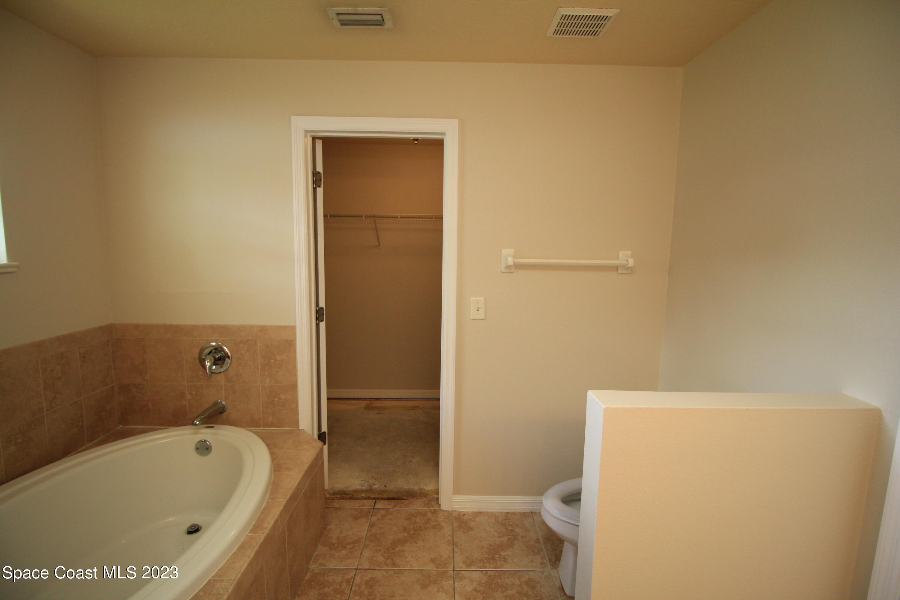 492 Eldron Boulevard Southeast Palm Bay, FL 32907 - Photo 28 of 28 a bathroom with a tub and toilet