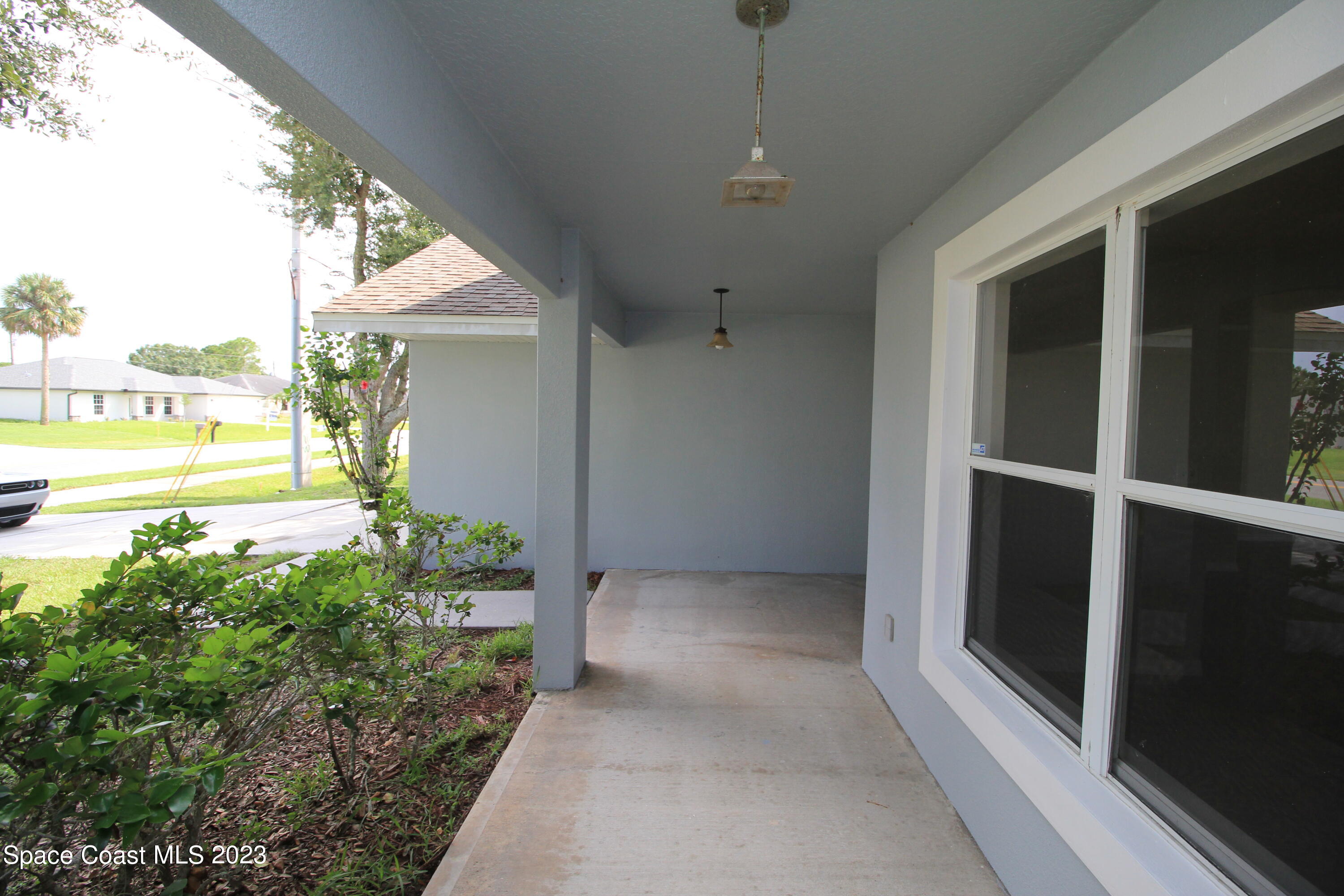 492 Eldron Boulevard Southeast Palm Bay, FL 32907 - Photo 3 of 28 a view of an entryway with garden