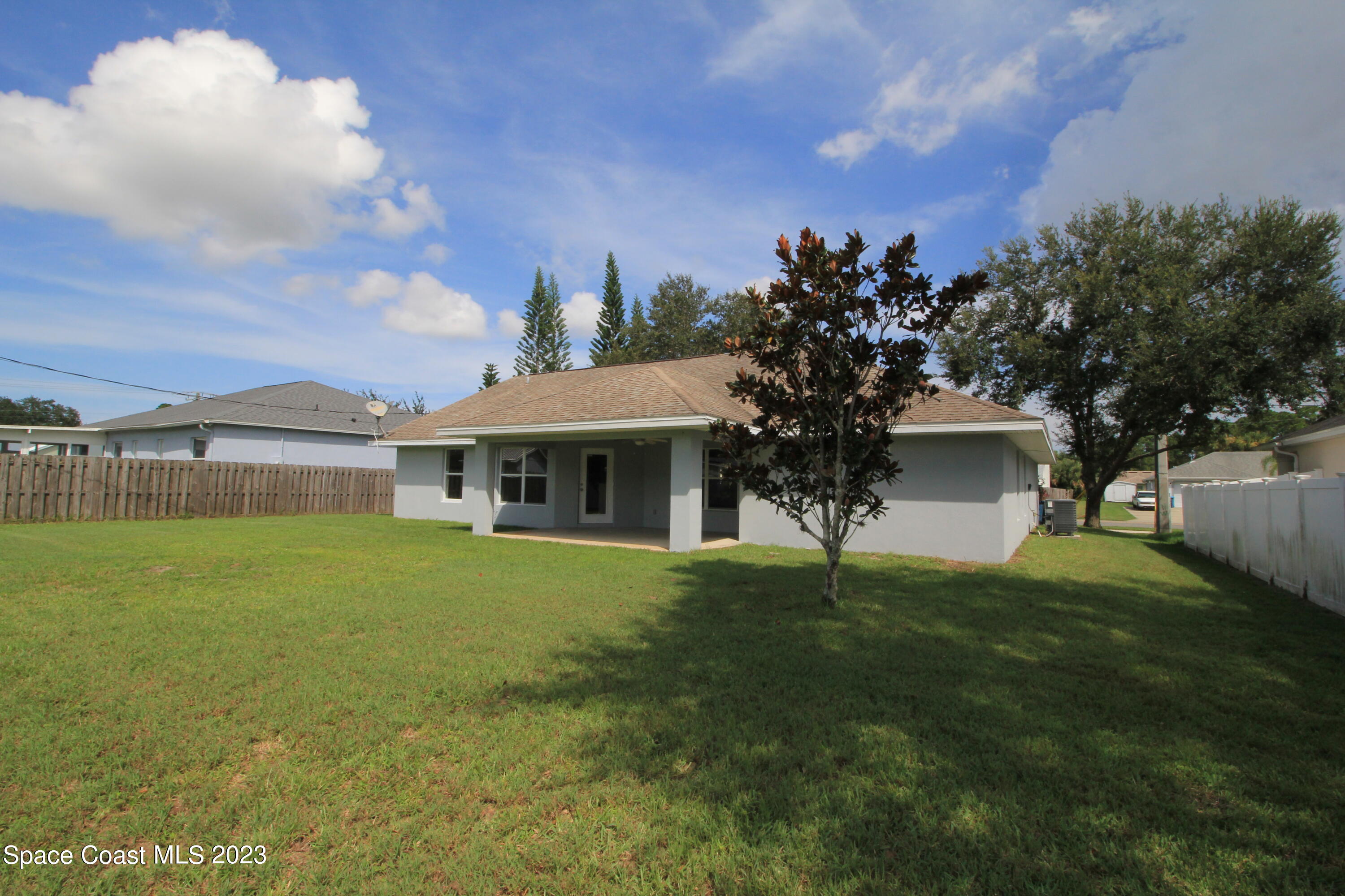 492 Eldron Boulevard Southeast Palm Bay, FL 32907 - Photo 7 of 28 a front view of a house with a garden