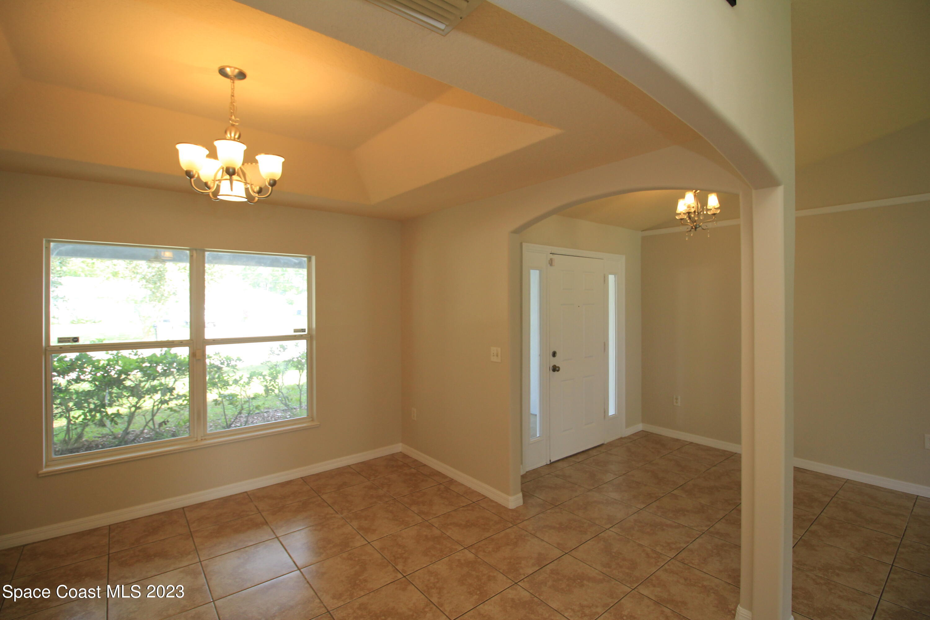492 Eldron Boulevard Southeast Palm Bay, FL 32907 - Photo 9 of 28 wooden floor in an empty room with a window