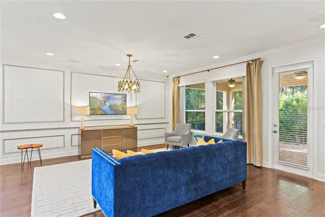 a kitchen with stainless steel appliances granite countertop a table chairs stove a sink and a refrigerator