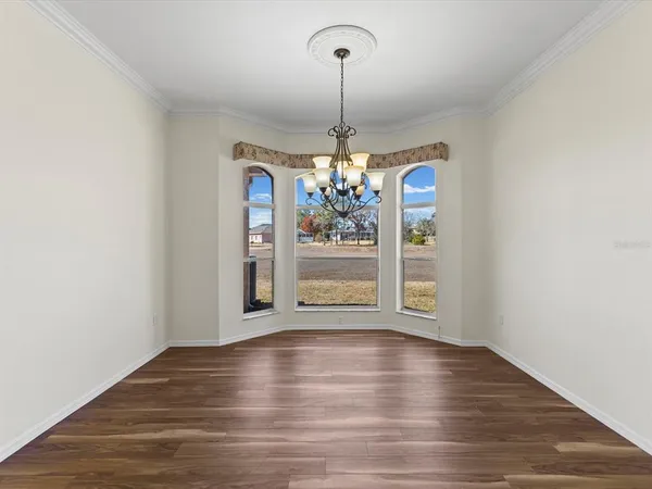 a living room with furniture and a view of kitchen