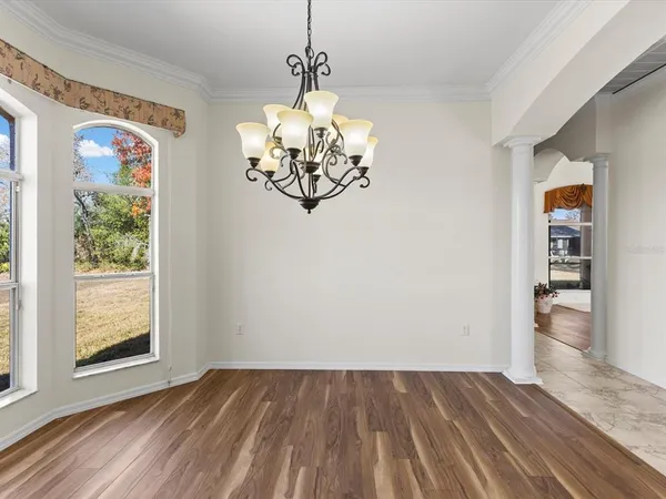 a living room with furniture a window and a ceiling fan