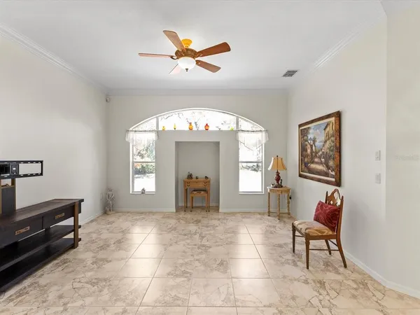 a view of a room with wooden floor and ceiling fan