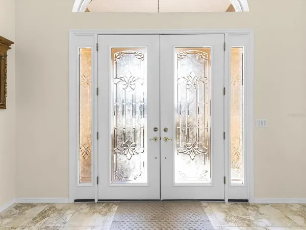 a large kitchen with stainless steel appliances granite countertop a stove top oven a sink dishwasher a dining table and chairs with wooden floor