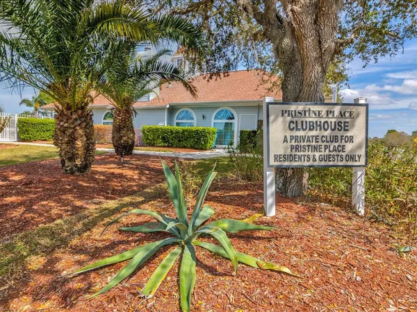 a view of a house with a big yard and dinning table and chairs with wooden floor