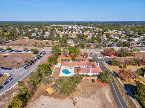 an empty room with windows and ceiling fan