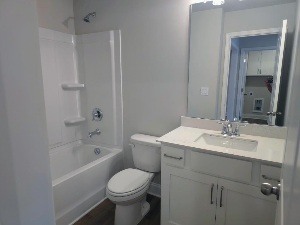 4240 Cavalier Way Duluth, GA 30097 - Photo 19 of 46 a bathroom with a sink toilet vanity and shower