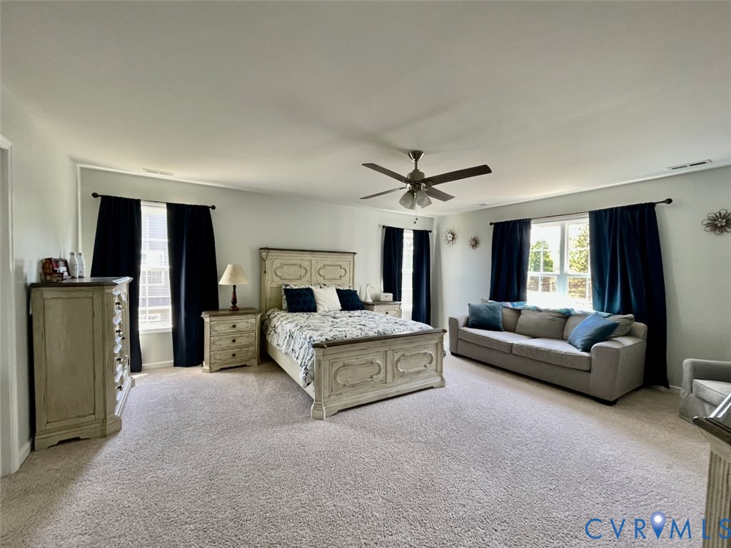9506 Simonsville Road Midlothian, VA 23112 - Photo 16 of 27 a living room with furniture and a chandelier