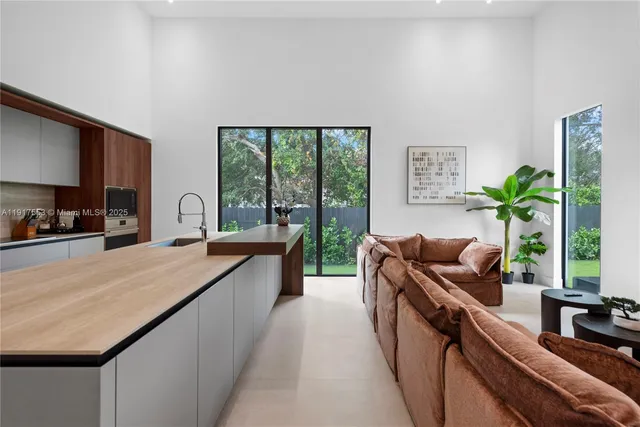 a view of a house with swimming pool and sitting area