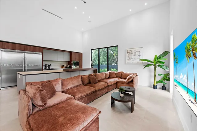 a view of swimming pool with outdoor seating and house in the background