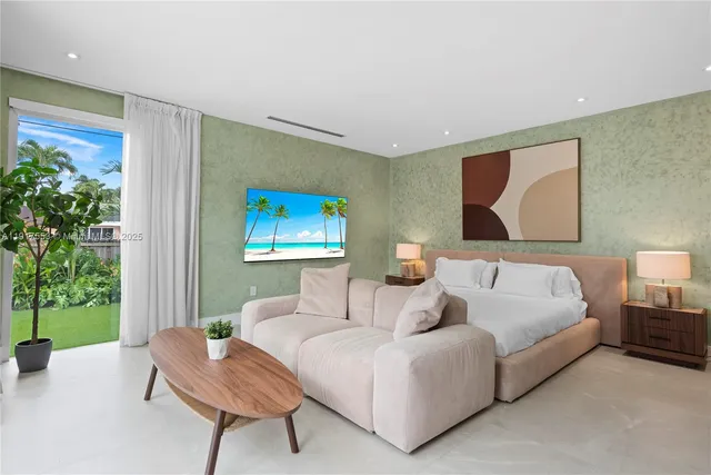 a living room with furniture and potted plants