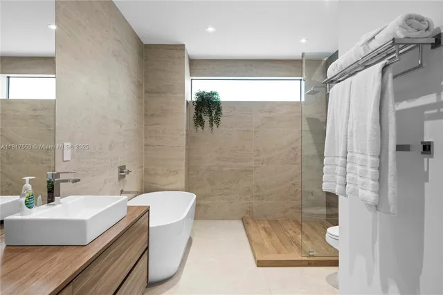 a bathroom with double vanity and a mirror