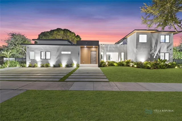 a view of a house with swimming pool lawn chairs and a yard