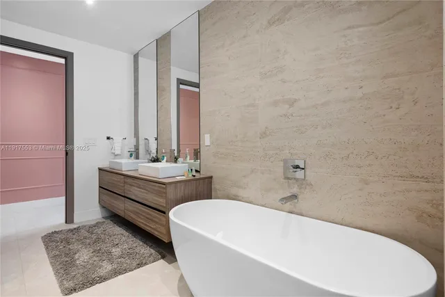 a bathroom with a sink vanity mirror and toilet