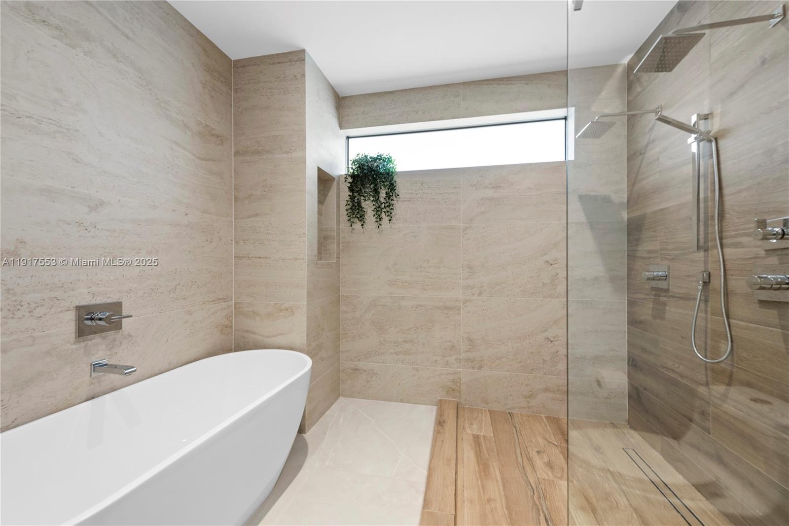 1881 Northeast 196th Terrace Miami, FL 33179 - Photo 32 of 98 a bathroom with a bathtub and shower