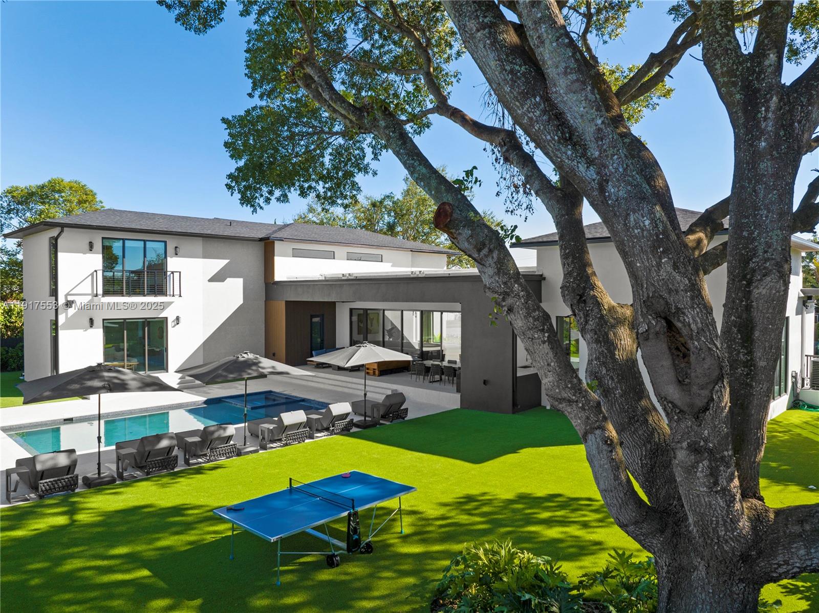 1881 Northeast 196th Terrace Miami, FL 33179 - Photo 34 of 98 a view of a house with swimming pool and porch with furniture