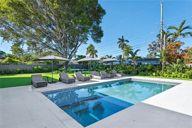 a bedroom with a bed lamp and a large window