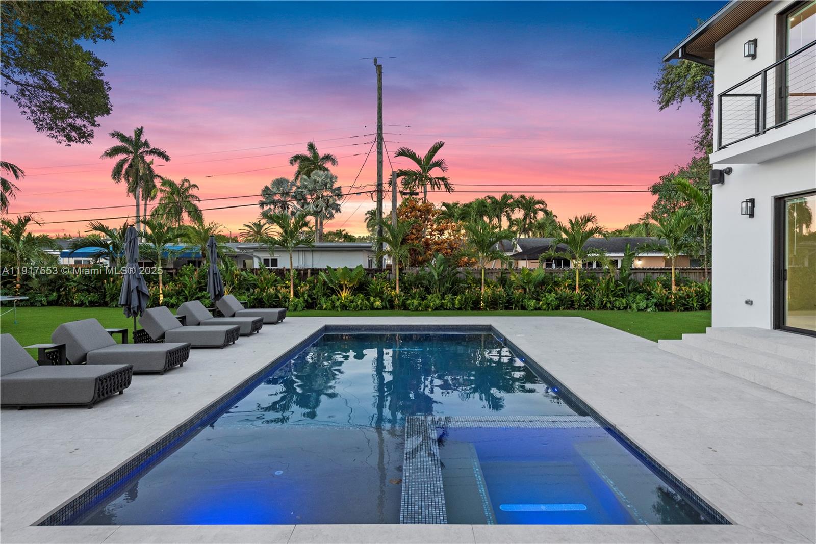 1881 Northeast 196th Terrace Miami, FL 33179 - Photo 42 of 98 a view of a patio with couches and a table and chairs with wooden fence